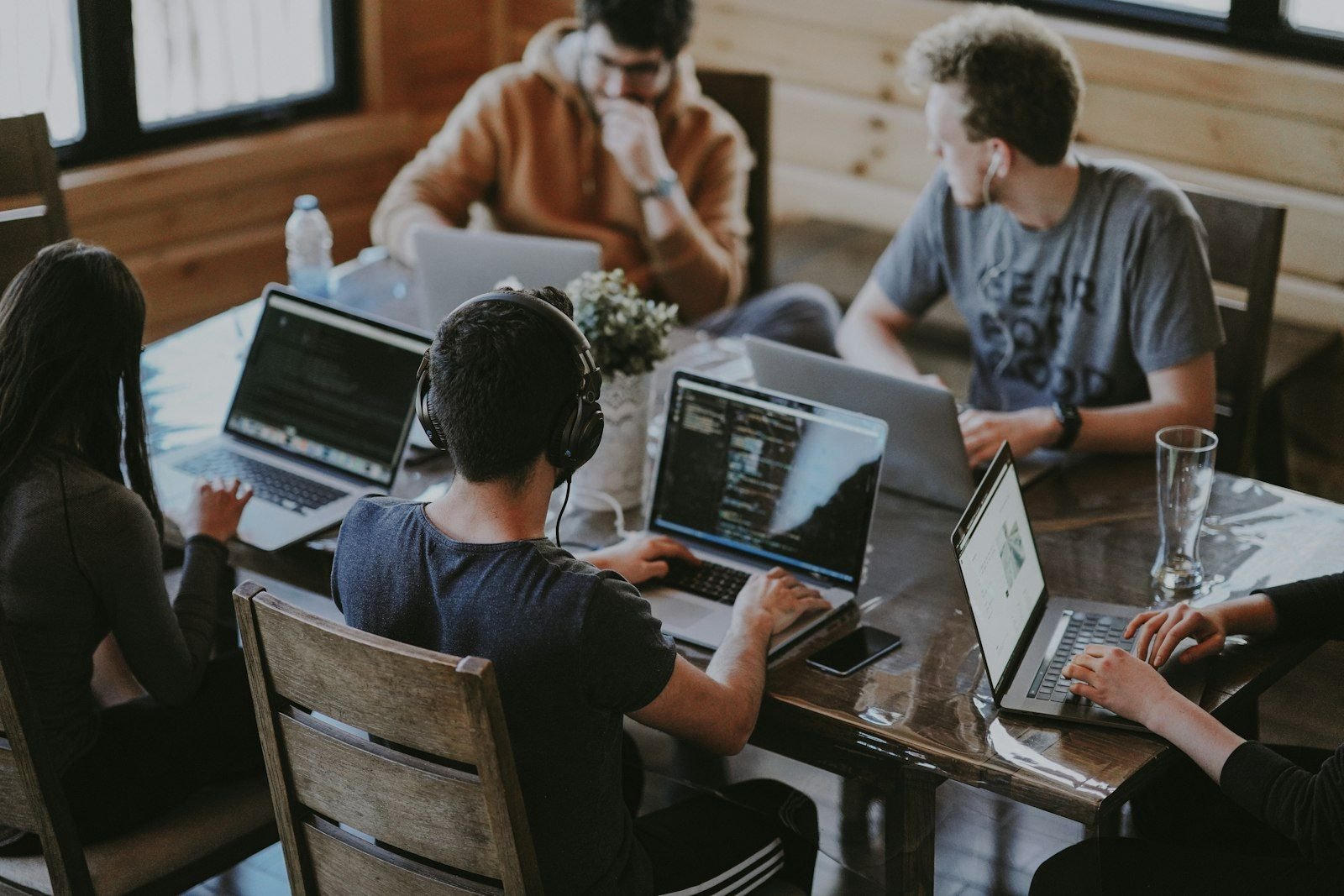 Four people grouped around a laptop, mid-discussion.